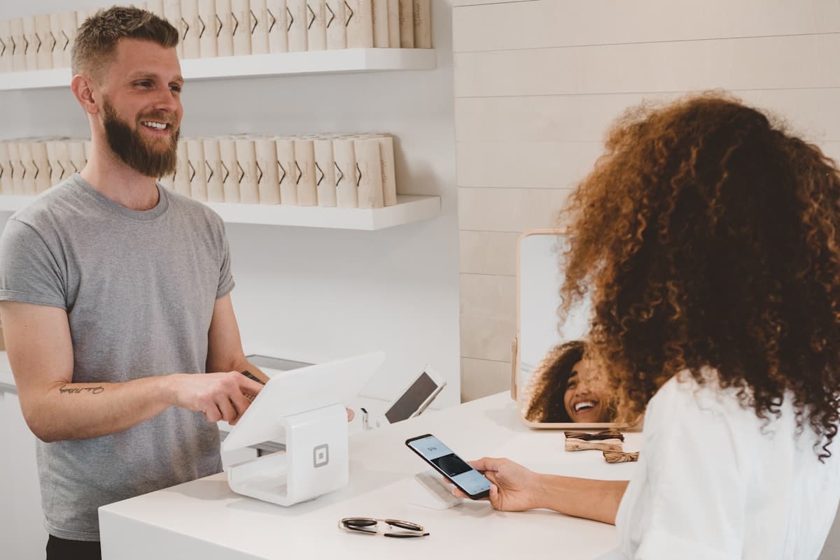 A business owner serving a customer at the counter